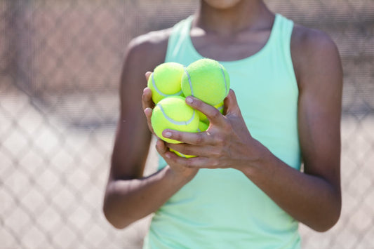 Girl holding tennis balls